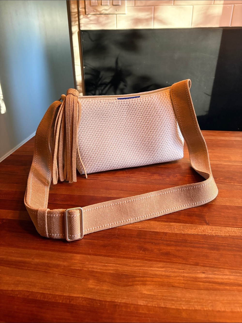 Rothy’s Casual Crossbody with tassle, tan and cream.